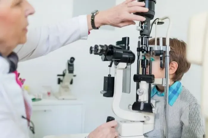 Patient réalisant un examen de vue avec un ophtalmologue pour évaluer sa vision